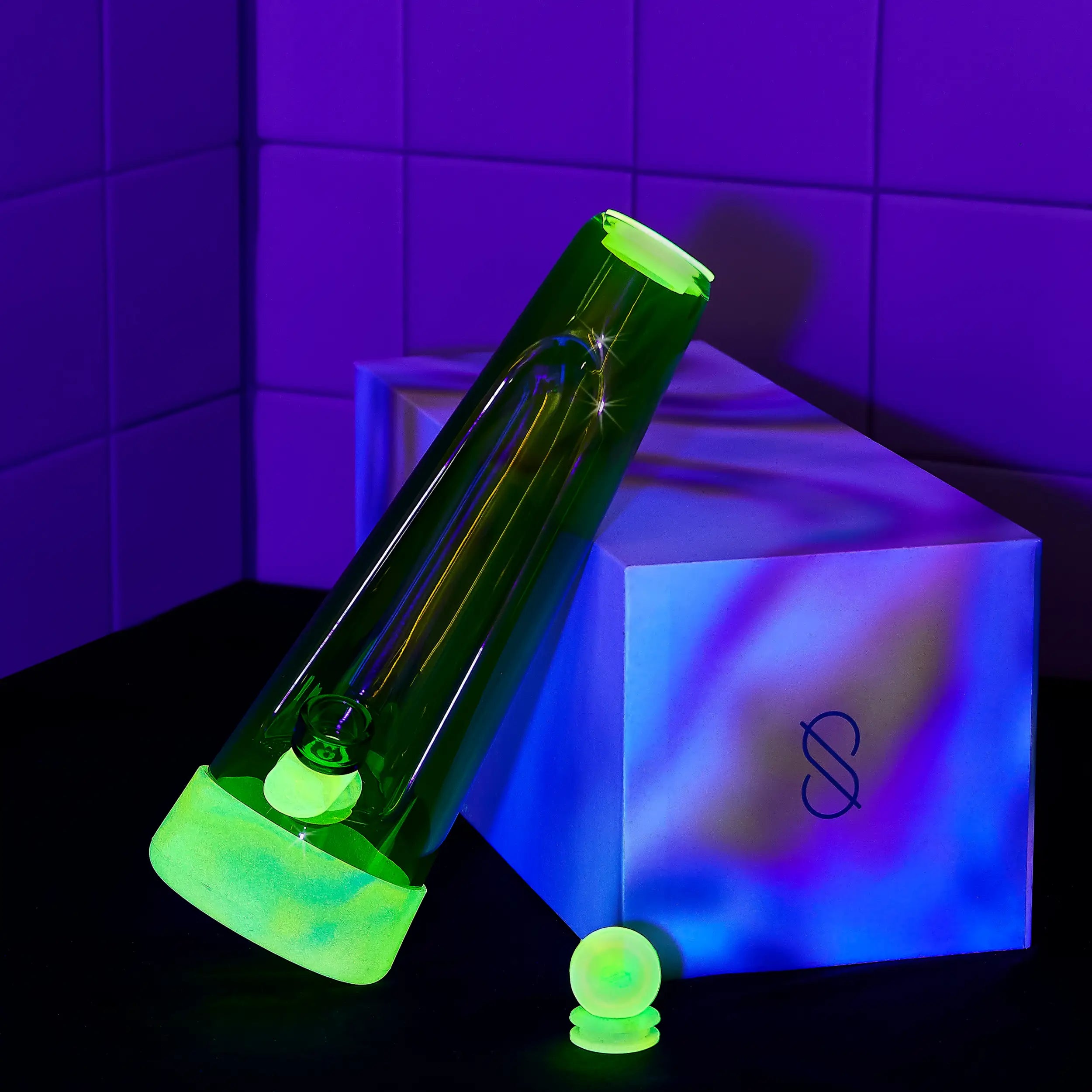 a glow-in-the-dark silicone Glow. Glass bong and pipe in blacklight of a session goods x weedfeed colllaboration