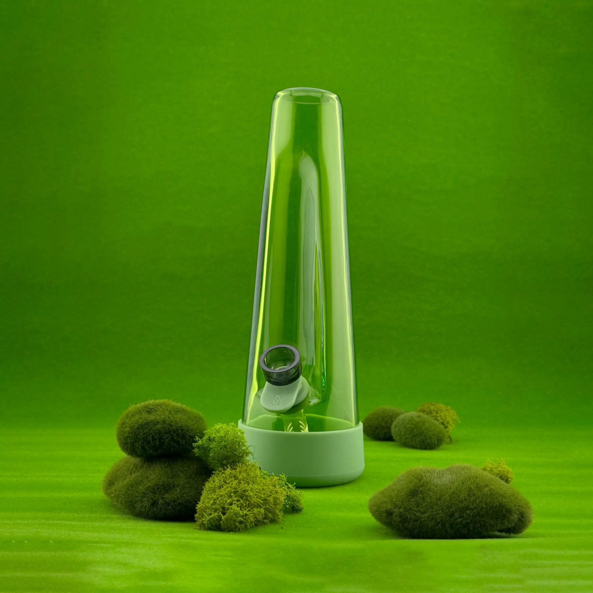Session Goods Grass Bong on a bright green backdrop with moss accents, blending nature-inspired design with modern aesthetics