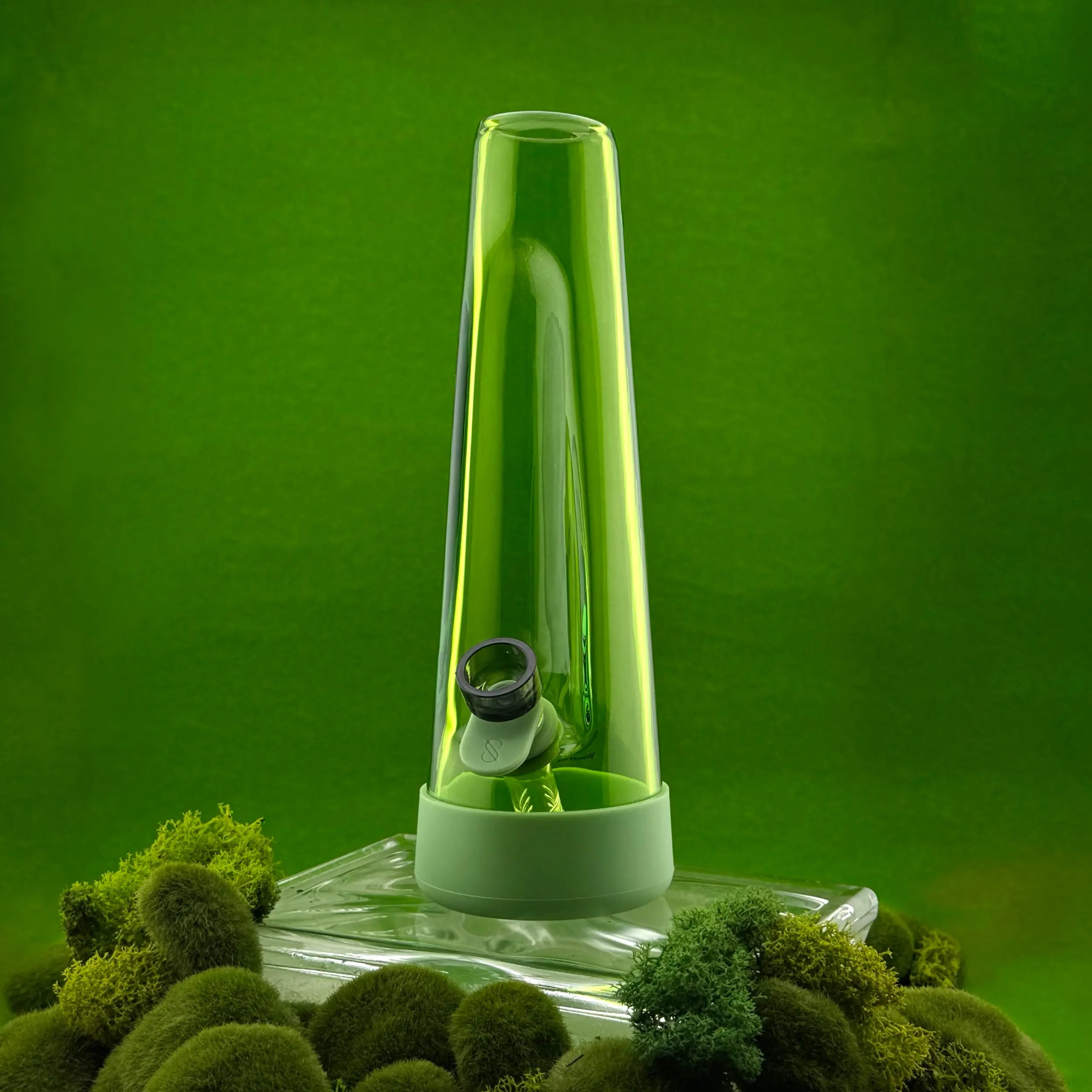 Green glass bong with a base on a green background