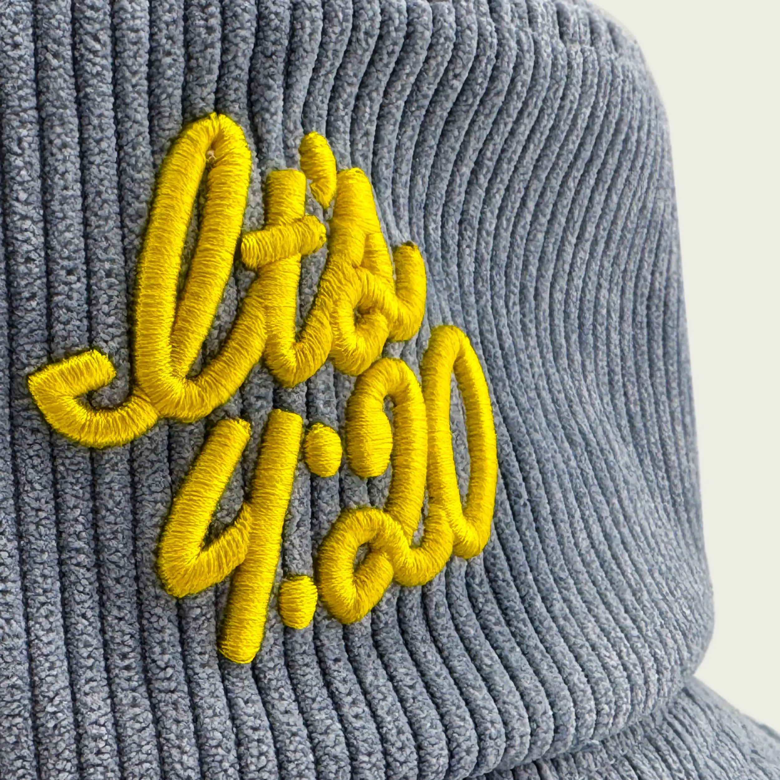 Close-up of “It’s 4:20” embroidery on a light blue Session Goods corduroy bucket hat