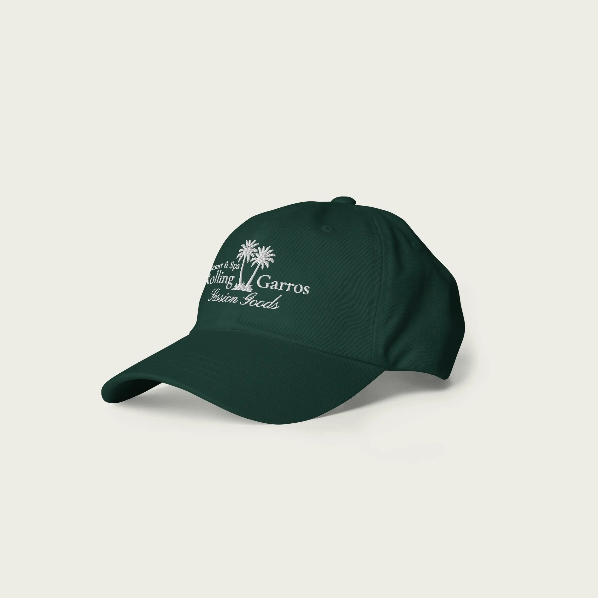 Side angle view of green Session Goods Rolling Garros dad hat with white embroidered palm tree and logo design.