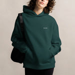 Back view of the pine green hoodie showing the clean, minimal design.