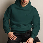 Model wearing the pine green Session hoodie, hands in front pocket.