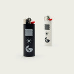Session Goods Normform B&W designer lighters, featuring a black lighter with white graphic and a white lighter with black graphic, both standing upright.
