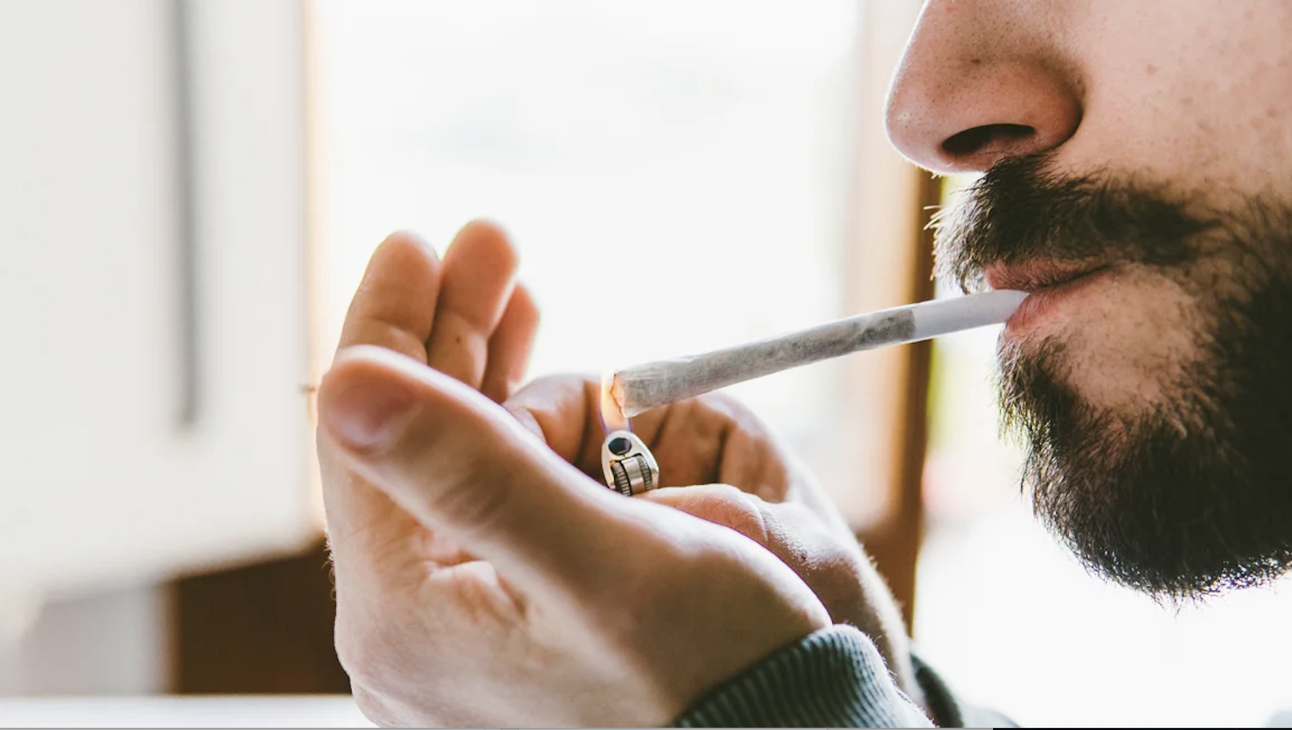 Man lighting a joint