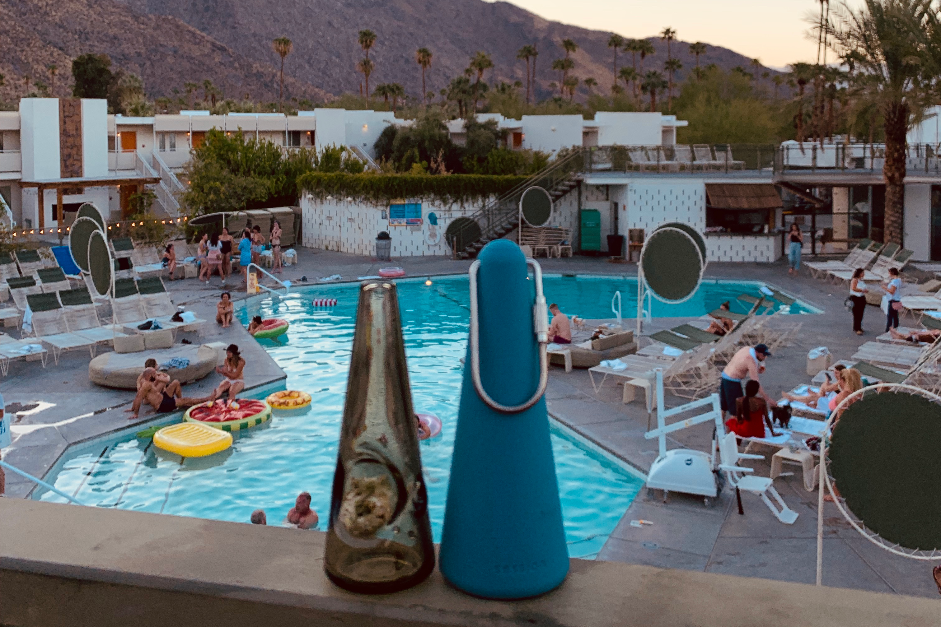 Indigo Session Goods pipe and sleeve on a railing overlooking a desert mountain and hotel pool at dusk.