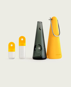 Paradise Featured 1 displays session goods portable glass hand pipe and stash pods in a background studio shot
