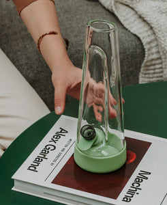 Elegant Glass water bong and silicone accessories on top of table. Featured 2