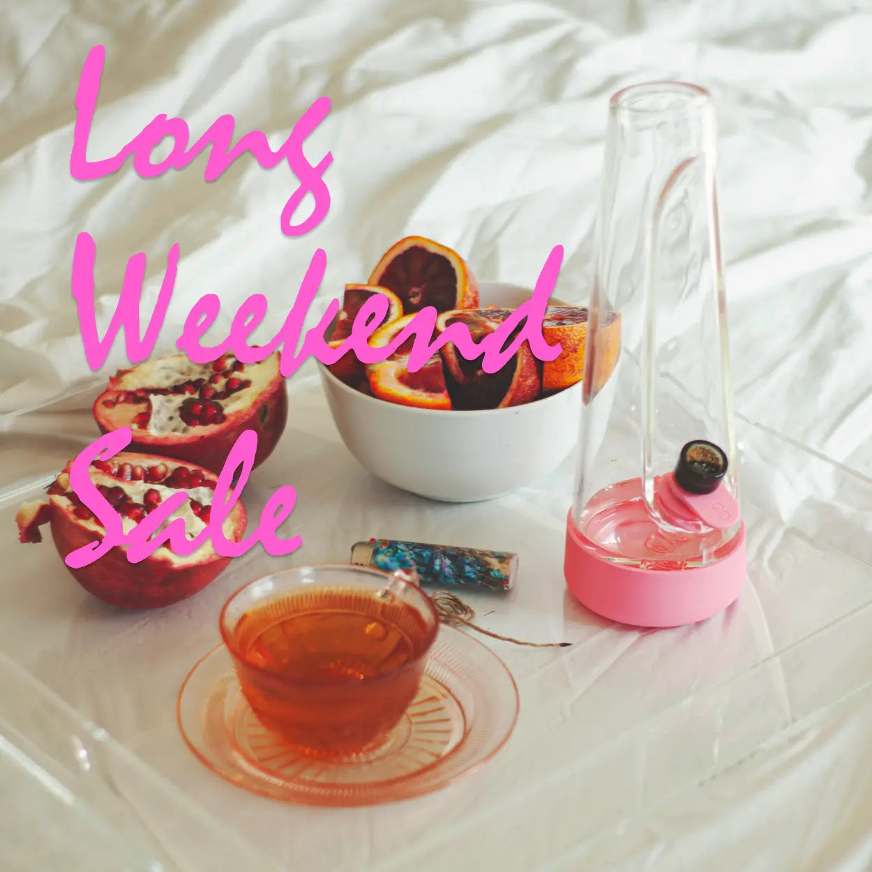 long weekend sale featuring a minimal design bong with blush silicone, on a clear tray with tea and fruit for relaxation