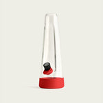 Session Goods designer bong in crimson red silicone, featuring a sleek modern design with a sturdy base, angled mouthpiece, and a removable silicone sleeve for added grip and durability.