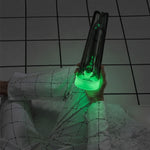 Overhead view of a person holding a glowing dark glass water pipe while sitting cross-legged.