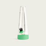 Minimalist Session Goods designer glass bong standing upright against a clean white background, showcasing the clear tapered glass and vibrant daytime lime green silicone base.