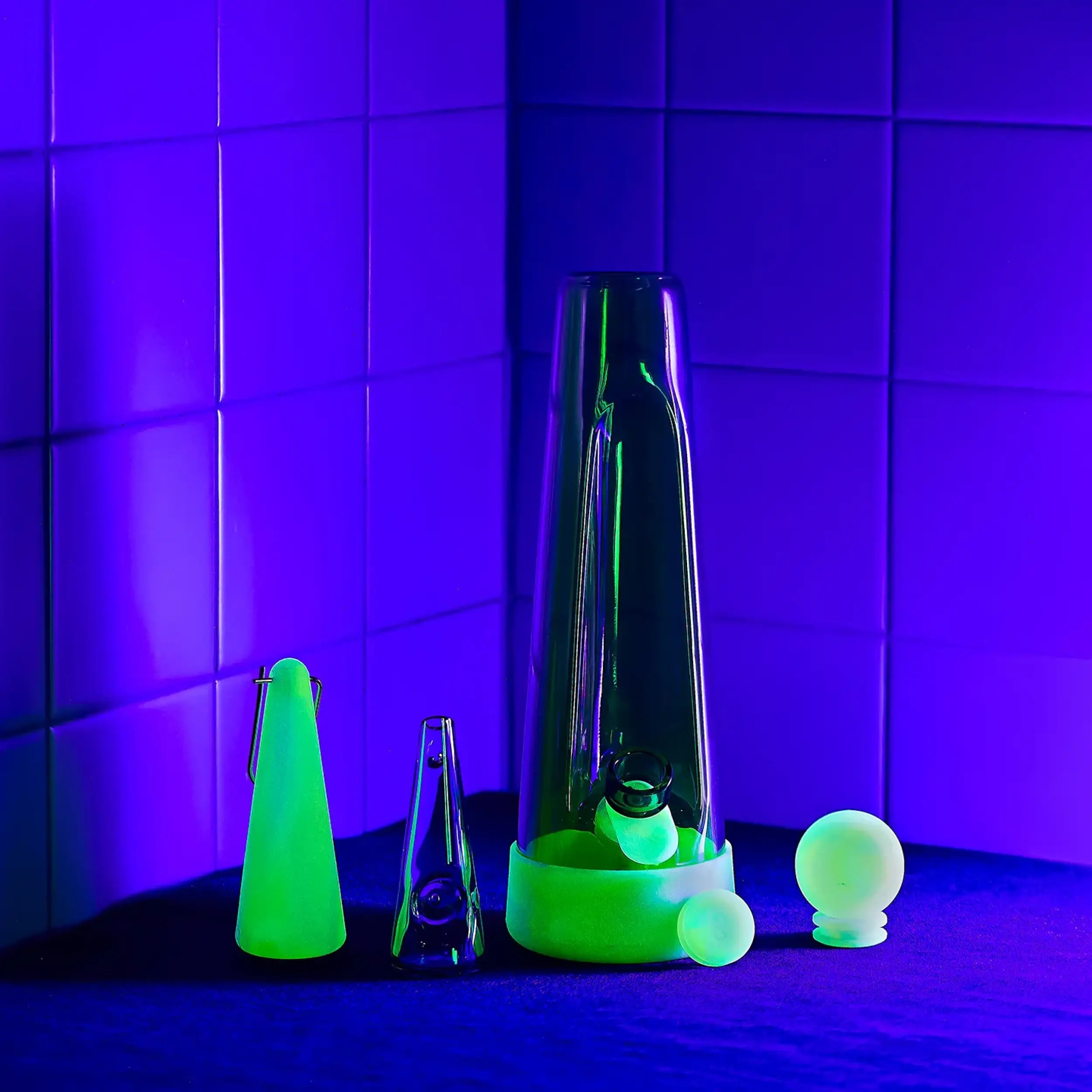 a glow-in-the-dark glass bong and pipe with silicone sleeve in collaboration with session goods x weedfeed.