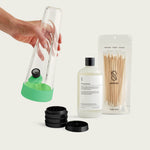 Session Goods Bong Starter Bundle in Glow Lime Green, including a glass water pipe, black grinder, cleaning solution, and cotton swabs.