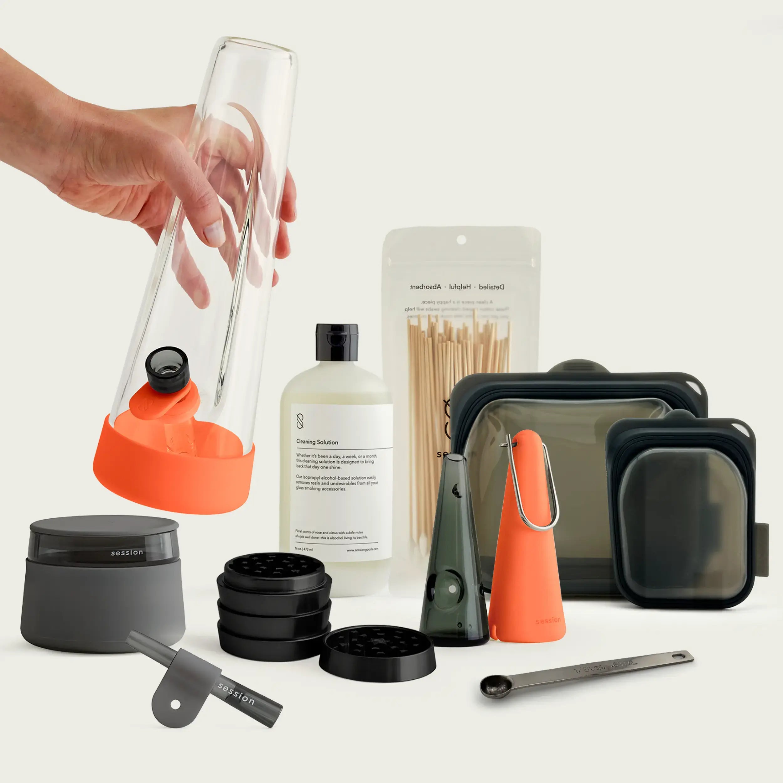 High-contrast Horizon Orange Session Goods bundle with a heat-tempered borosilicate glass bong, silicone cleaning pouch, and measuring spoon, inspired by mid-century modern design.