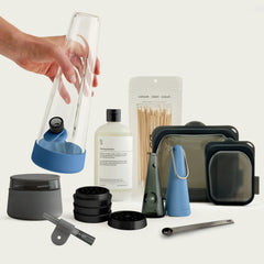 The Session Goods Indigo bundle featuring a deep blue silicone-wrapped glass bong, portable pipe, and precision metal grinder, designed as functional industrial decor for a professional home.