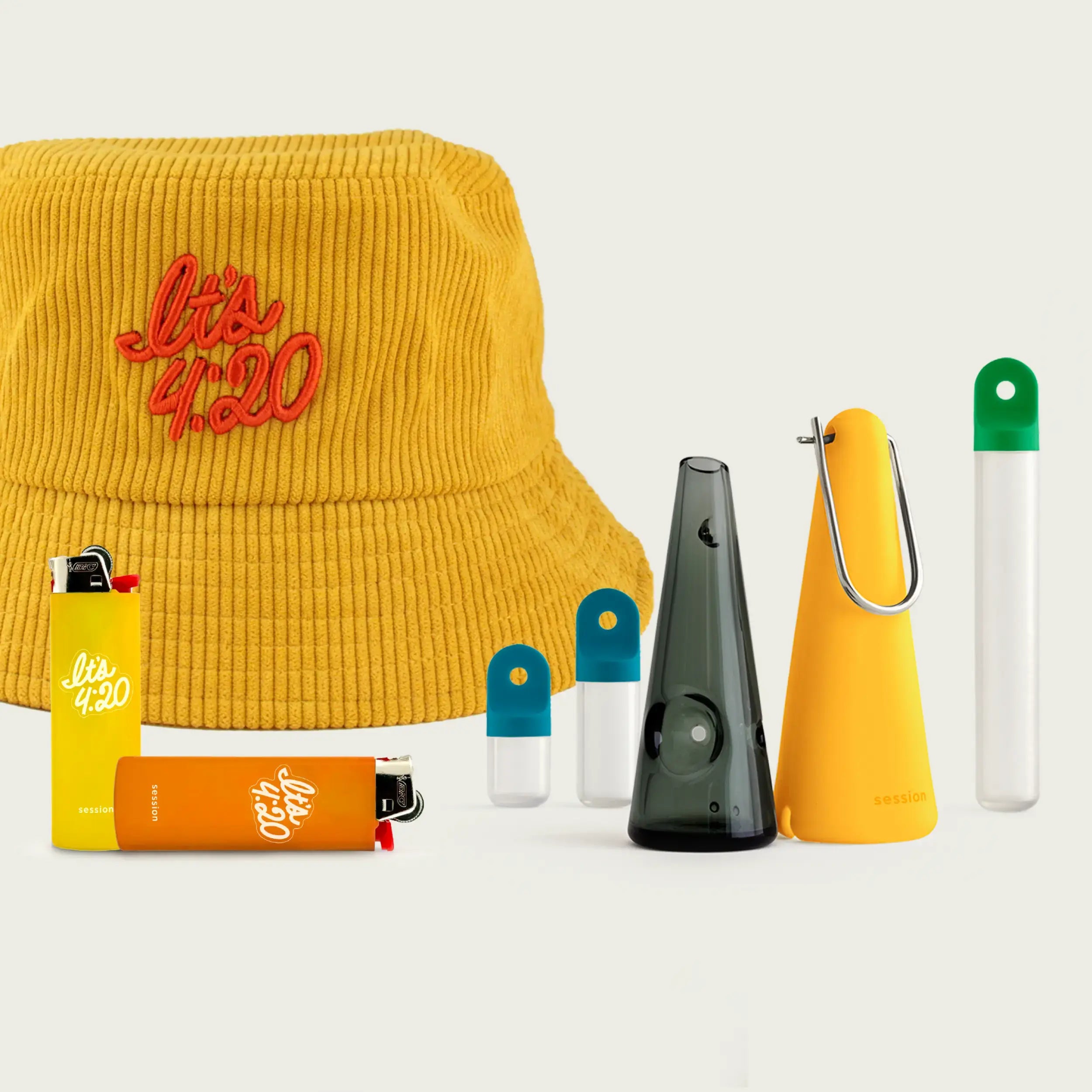 Session Goods Back to School Bundle featuring a mustard yellow corduroy bucket hat embroidered with ‘It’s 4:20’ in red, a translucent one-hitter pipe with an orange cone sleeve, two colorful stash pods, yellow and orange ‘It’s 4:20’ branded lighters, and a clear stash tube with a green cap — all arranged on a light neutral background.