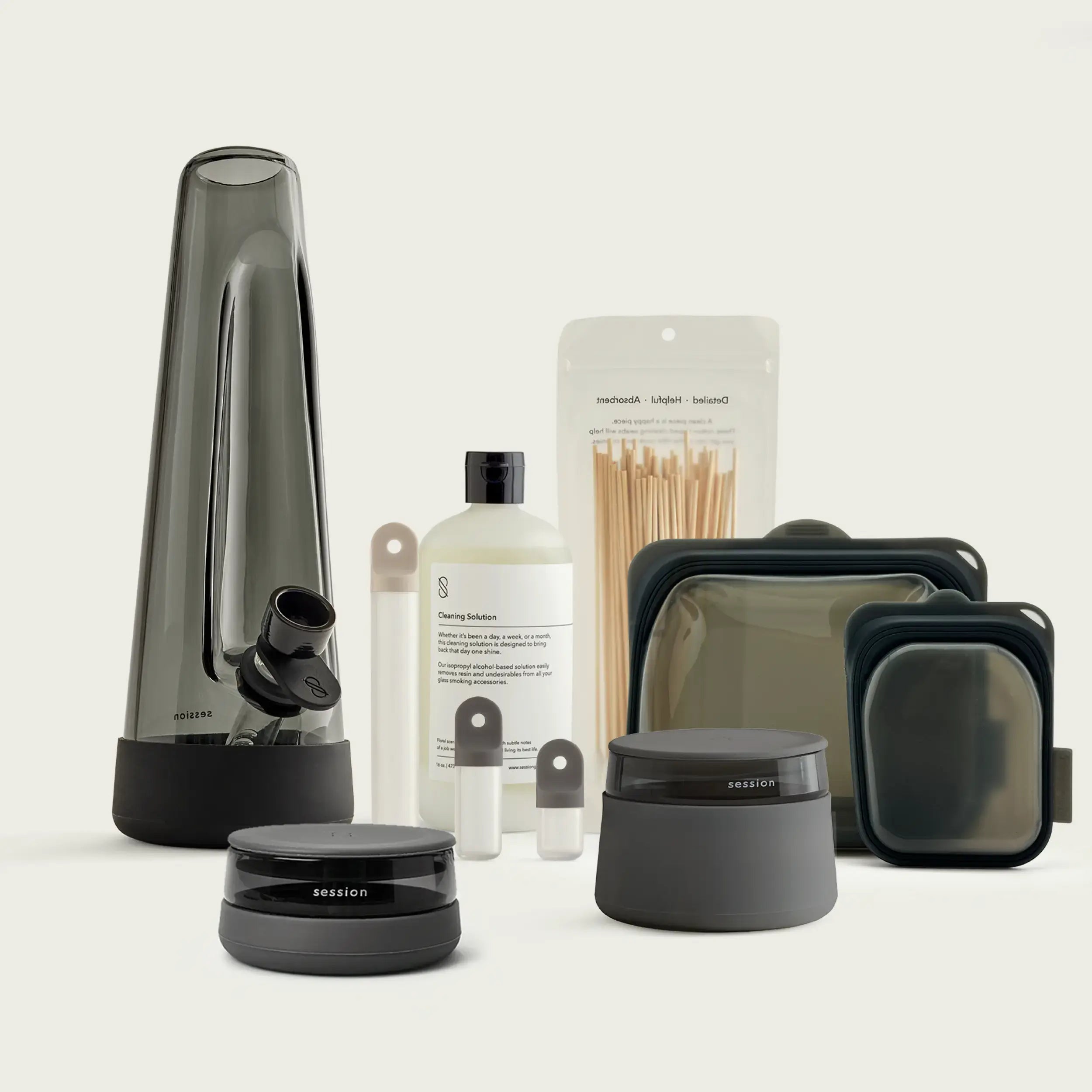 Session Goods Ultimate Bong Bundle in Ash, featuring the designer black glass bong, matching debowler ashtray, stash jar, and black and white designer lighters.