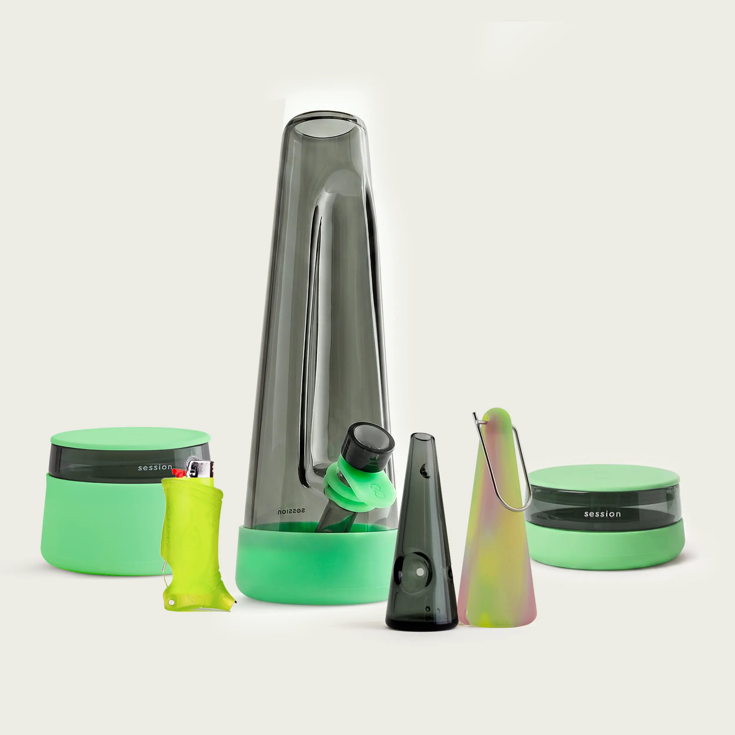 Complete Session Goods Ultimate Designer Glow Bundle including a smoky black glass bong, stash jar, low-profile ashtray, Aura pipe with protective sleeve, and a Toker Poker lighter case, all accented with glow-in-the-dark green silicone.