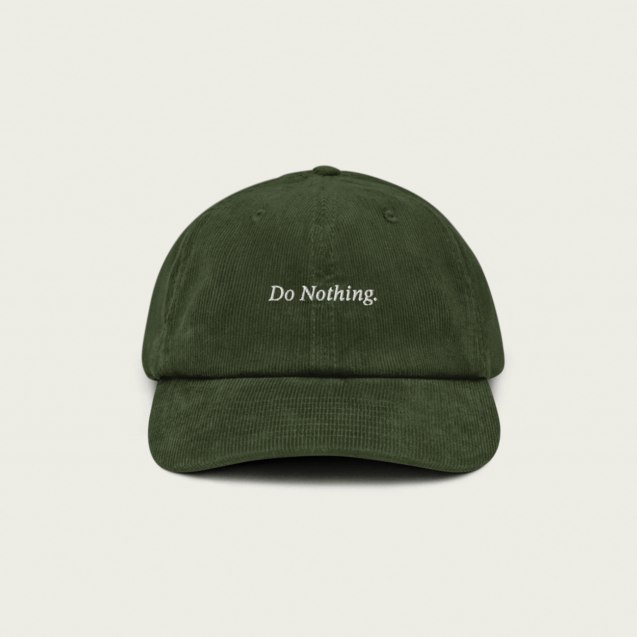 Animated GIF showing a Session Goods olive green corduroy dad hat slowly floating up and down against a clean cream background. The front features white embroidered text that reads "Do Nothing."