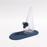 Session Goods ribbed clear glass Drop Bubbler featuring a slate blue silicone grommet tab and matching silicone mat, fitted with a dark glass bowl piece.