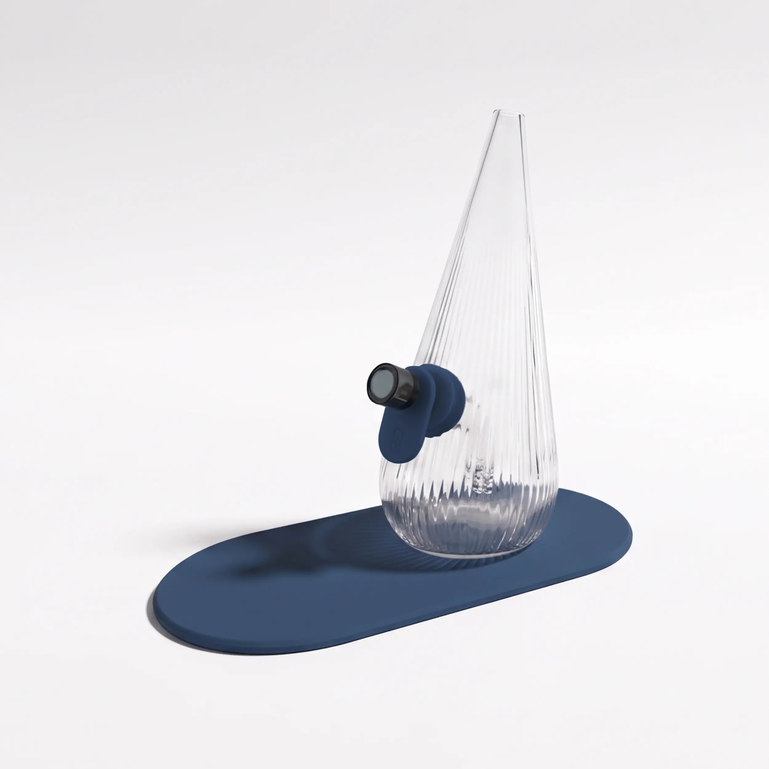 Session Goods ribbed clear glass Drop Bubbler featuring a slate blue silicone grommet tab and matching silicone mat, fitted with a dark glass bowl piece.