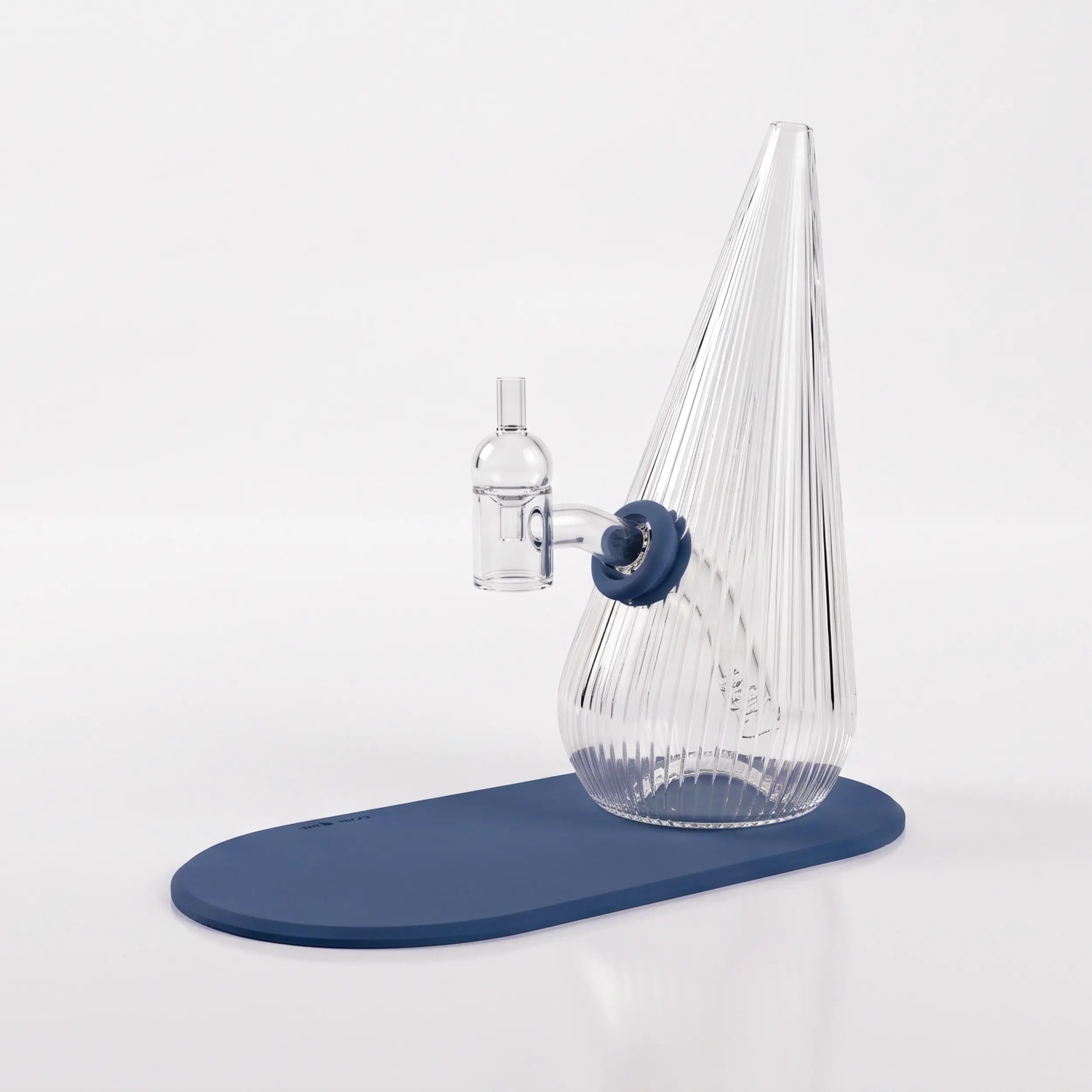 Session Goods ribbed clear glass dab rig with a slate blue silicone grommet and matching slate blue silicone mat, fitted with a clear quartz banger and carb cap.