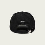 Close-up of ‘Do Nothing’ embroidery on black corduroy dad hat.