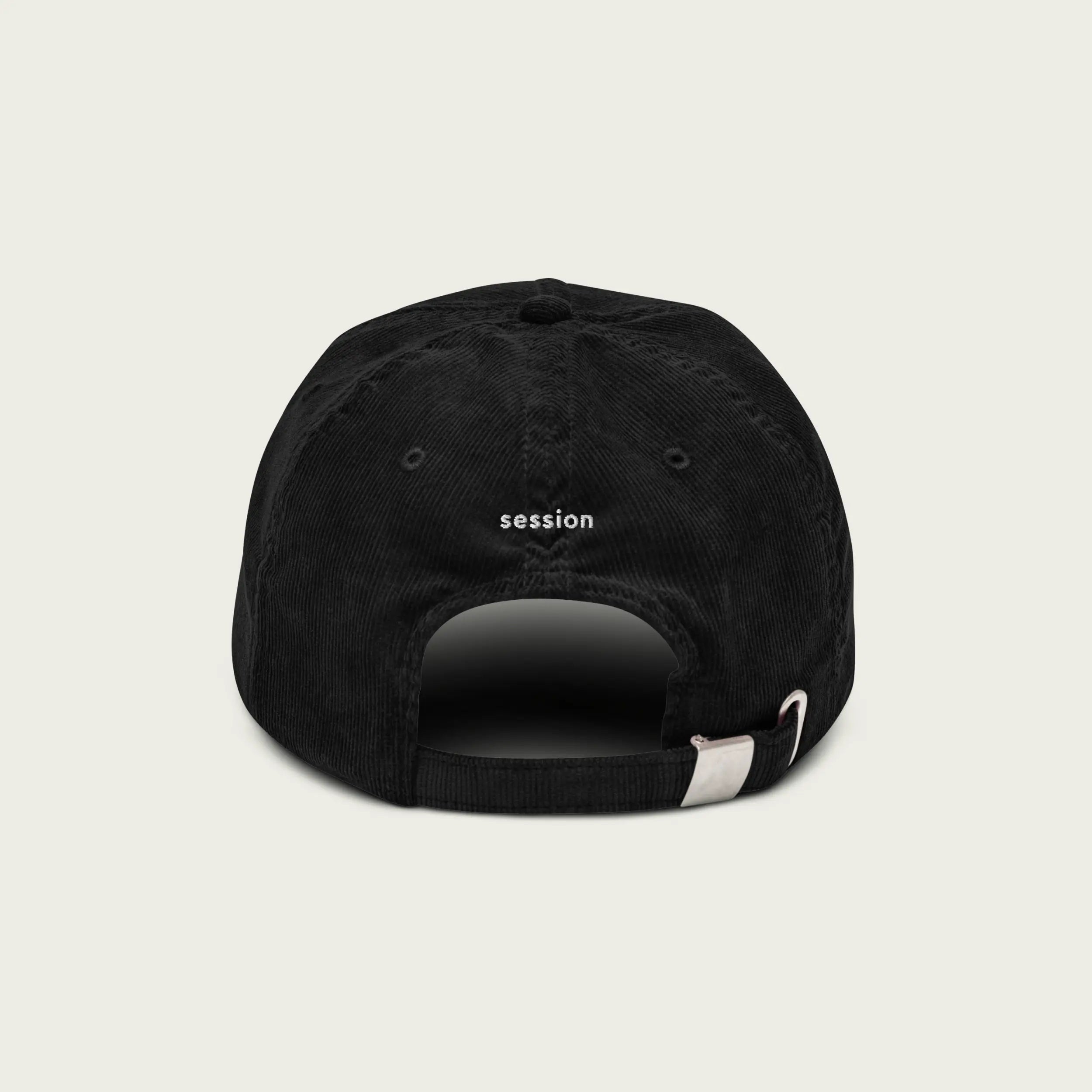 Close-up of ‘Do Nothing’ embroidery on black corduroy dad hat.