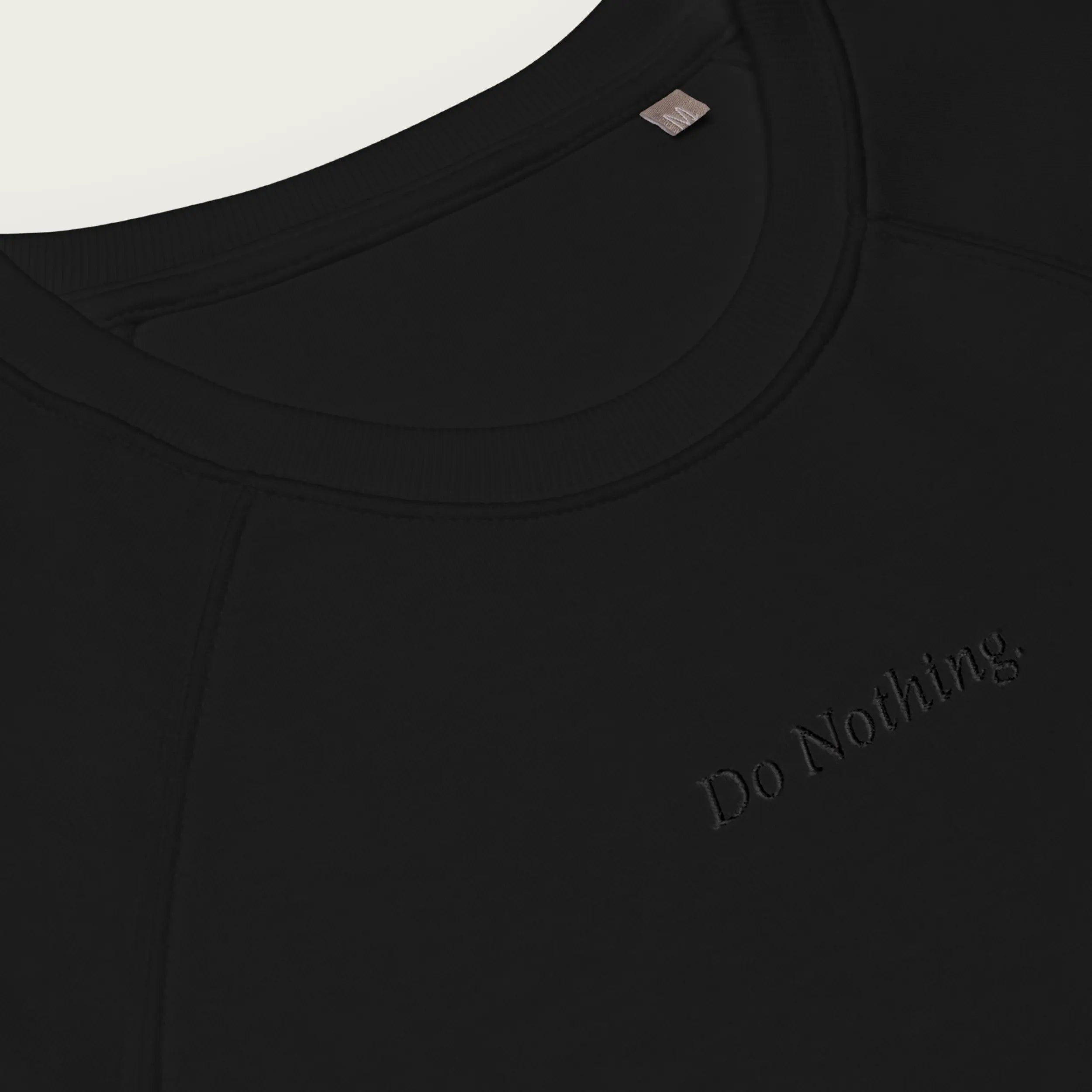 Comfortable black sweatshirt featuring subtle ‘Do Nothing’ embroidery