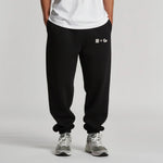 Person wearing black sweatpants with a 'Normform' logo on a gray background