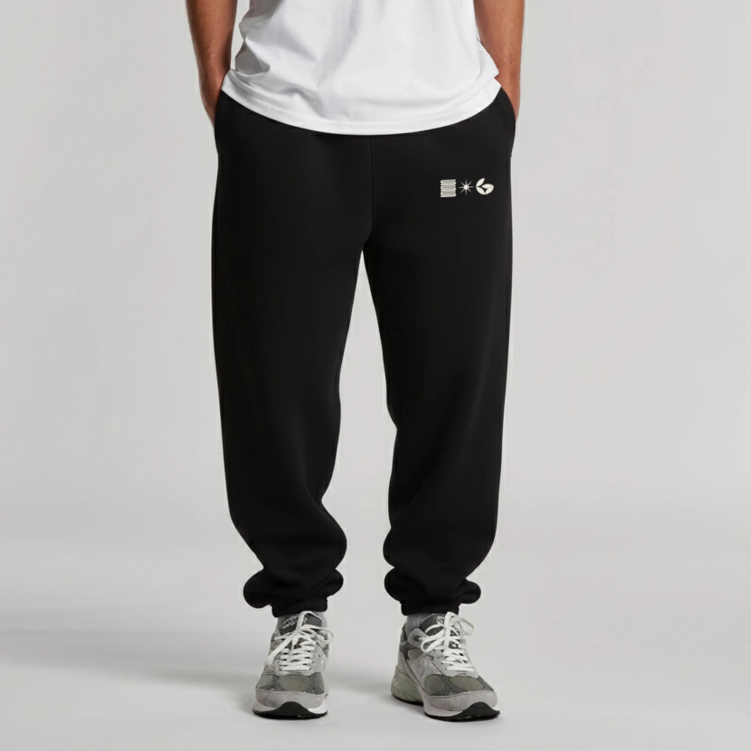 Person wearing black sweatpants with a 'Normform' logo on a gray background