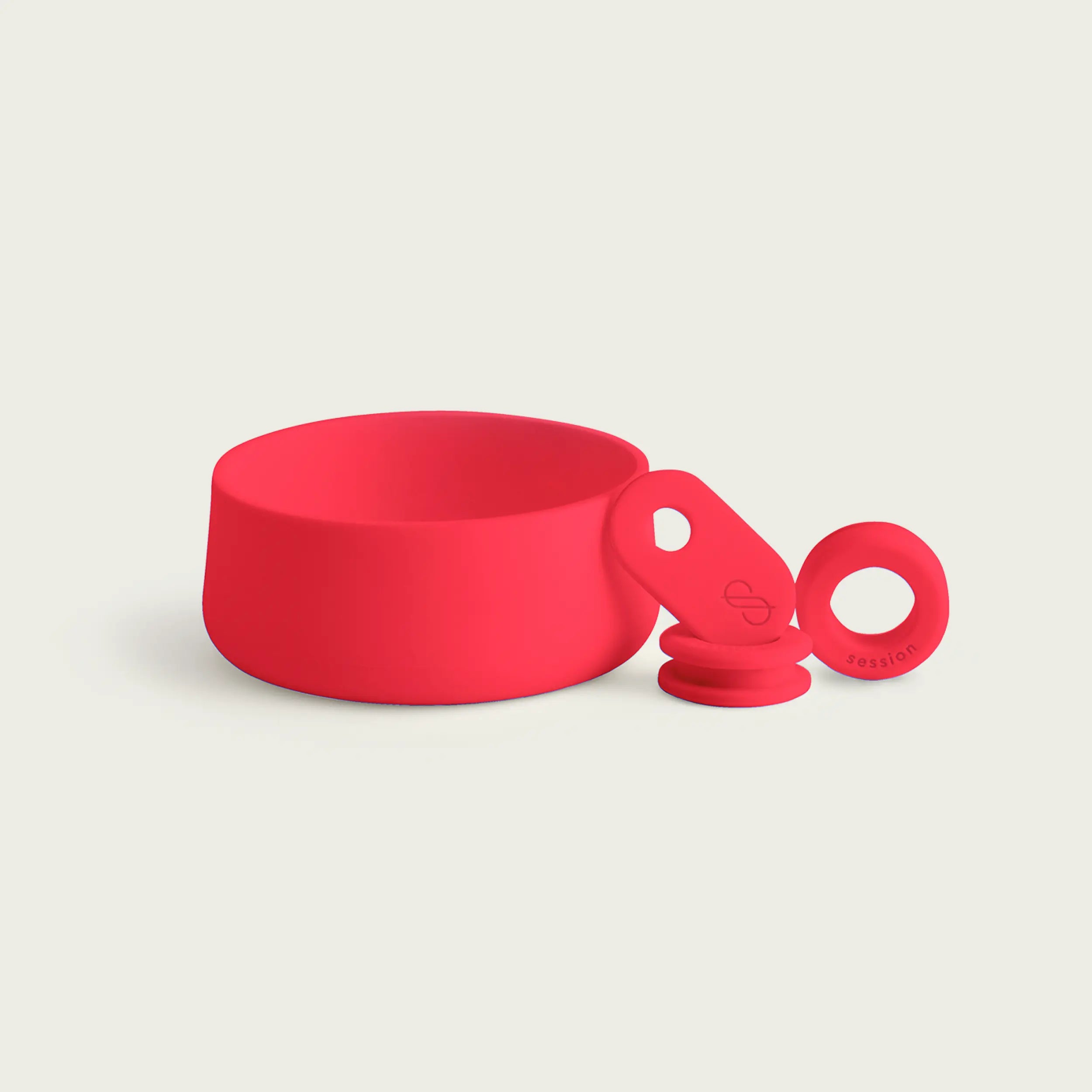 A set of Session Goods cherry red silicone bong accessories resting on a white background, including a protective base cover, a branded pull tab, and a grommet.