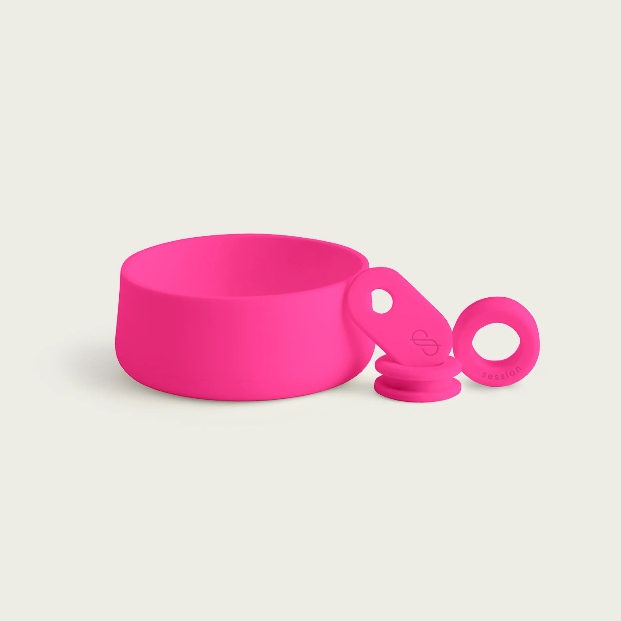 A studio shot of the Magenta Pink Silicone Accessory Kit for the Session Bong, featuring a vibrant pink silicone footer, a matching bowl pull tab with a debossed logo, and two precision-engineered airtight grommets.