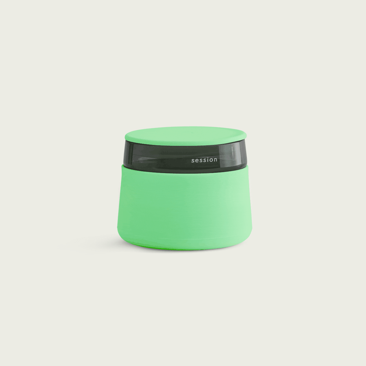 The Session Goods lime green stash jar and ashtray fully illuminated in a dark studio, showcasing its bright glow-in-the-dark silicone body and lid against a black background.