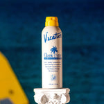 Vacation Classic Spray SPF 50 Sunscreen bottle placed against a pastel background, showcasing its retro-inspired design with bright, bold colors reminiscent of 1980s summer aesthetics.