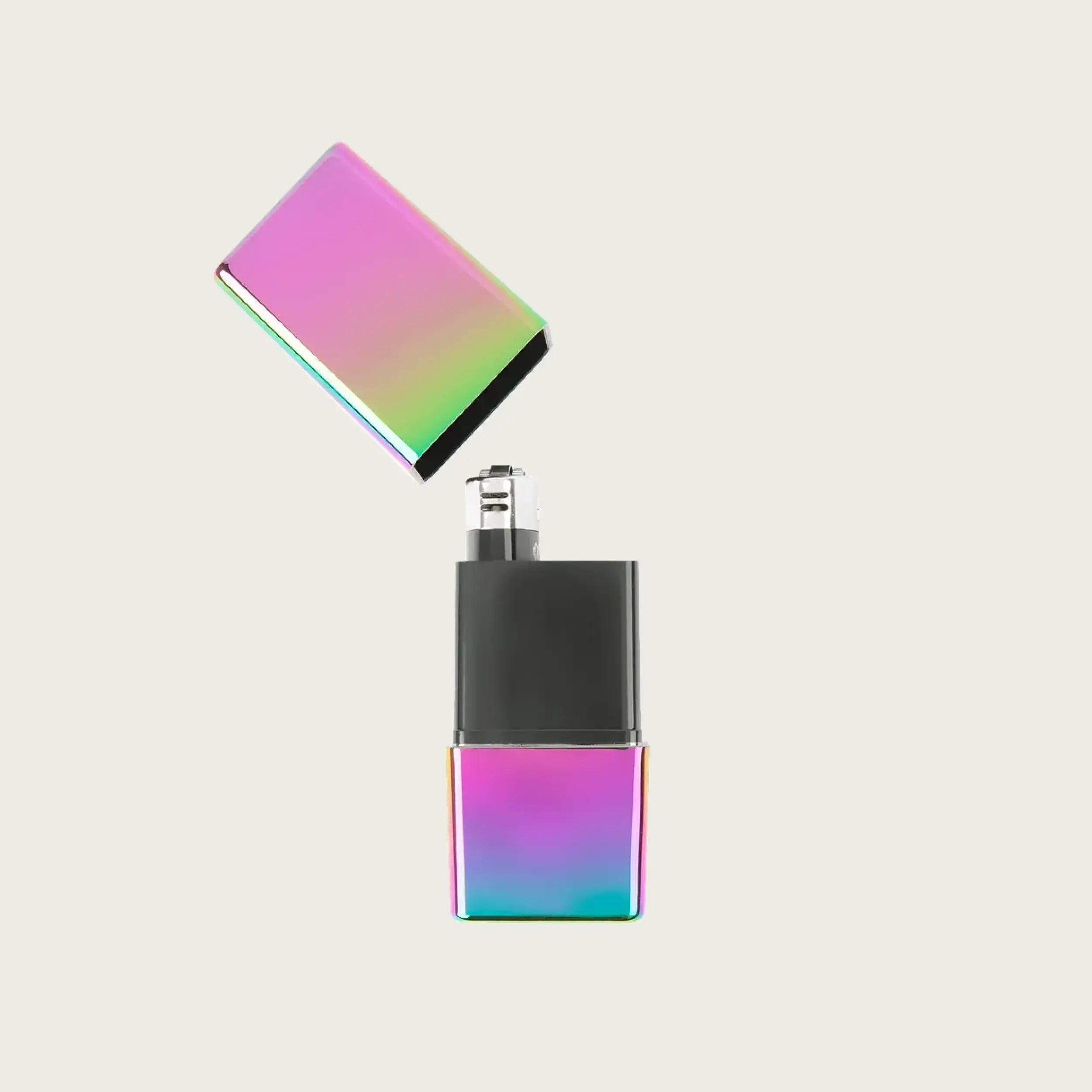 An open Black Pearl OG Hautebox by Charlotte Welch, highlighting the compact internal compartments and the iridescent, oil-slick aesthetic of the Black Pearl finish.